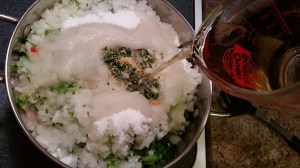 Adding vinegar to the vegetables in the pot