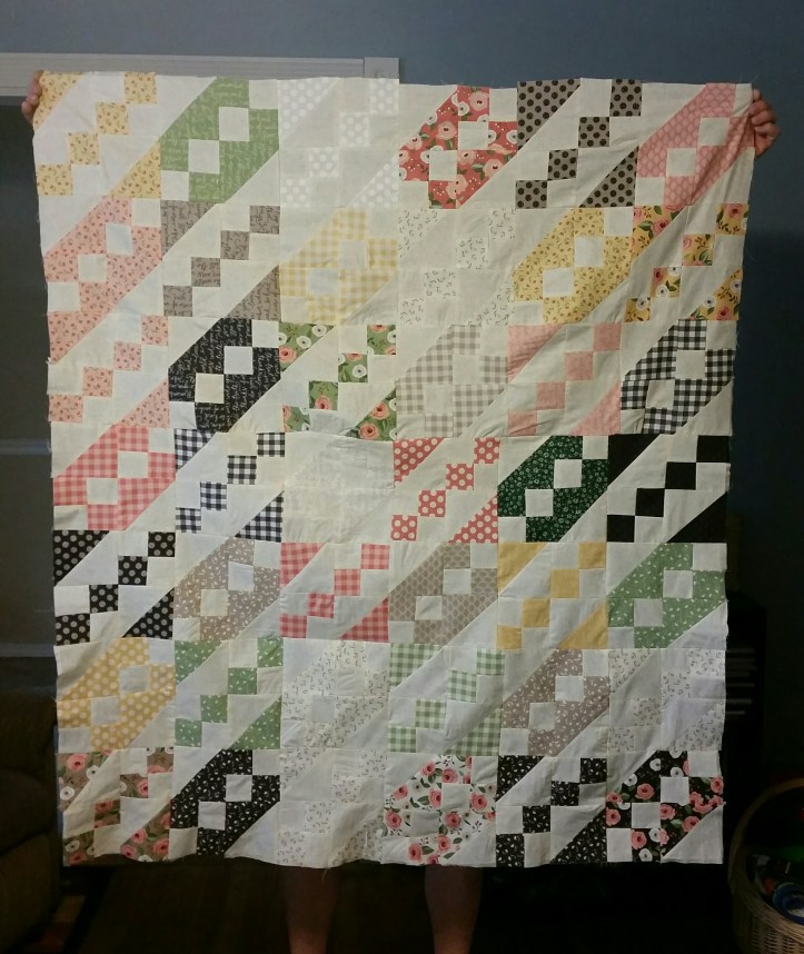 holding quilt up