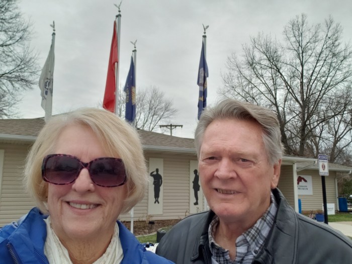 A man and a woman standing in front of a military museum