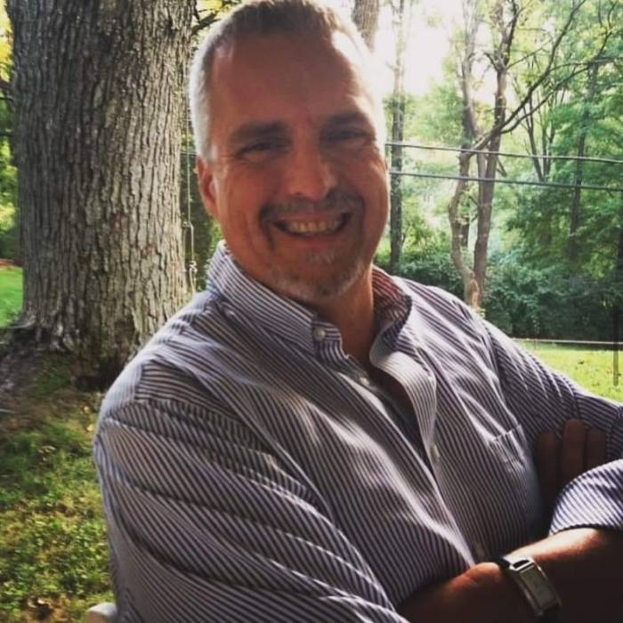 Man standing with his arms folded