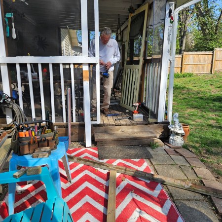 Man working on wooden deck repair